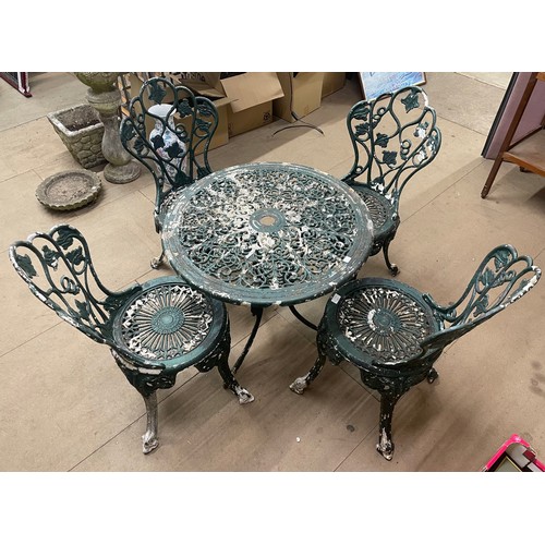 245 - A cast alloy garden table and four chairs