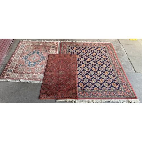 204 - Three eastern red ground rugs; 200 x 140cms,
159 x 105cms and 136 x 67cms