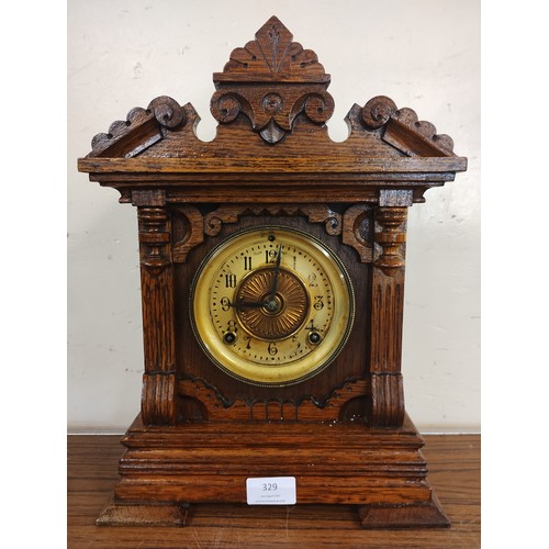 329 - A early 20th Century American Ansonia carved oak mantel clock