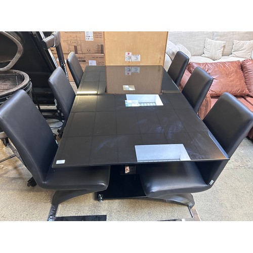 1489 - A Tfu-Nicha black glass dining table with six upholstered chairs