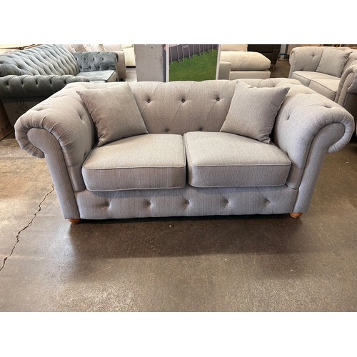 1460 - A grey weave Chesterfield two seater sofa