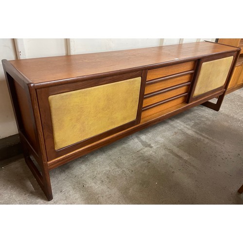 25 - A teak and vinyl sliding door sideboard