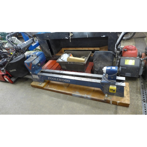 2212 - A Poolewood Prestige PW 35/40, 5ft, wood turning lathe with a box of assorted attachments and tools