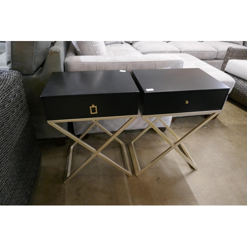 1360 - A pair of black bedside tables with silver crossed legs - one missing handle