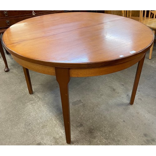 65 - A teak circular extending dining table