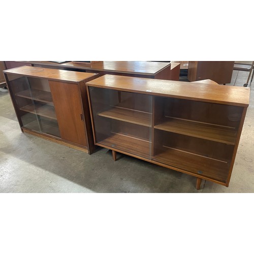 68 - An Avalon teak and glass sliding door bookcase and one other