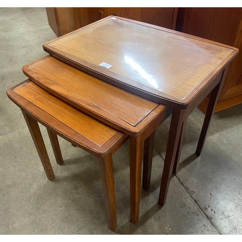 71 - A teak and glass topped nest of tables