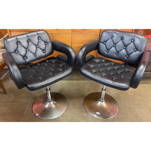 90 - A pair of chrome and black faux leather adjustable bar stools