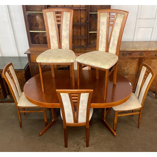 100 - A teak extending dining table and six dining chairs