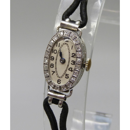 1002 - A lady's platinum and diamond cocktail watch, hinge a/f, case 2cm x 1.3cm