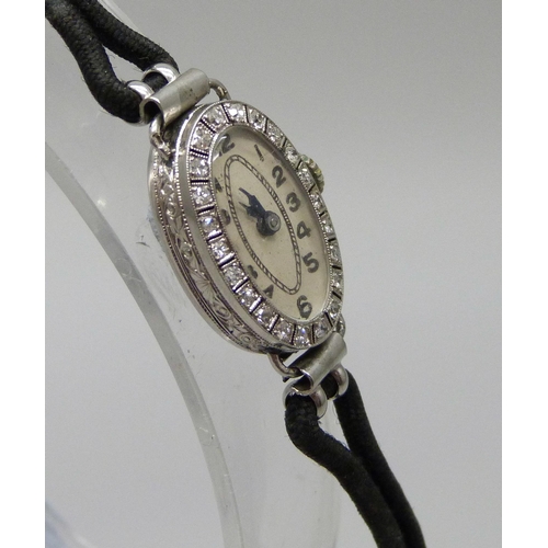 1002 - A lady's platinum and diamond cocktail watch, hinge a/f, case 2cm x 1.3cm