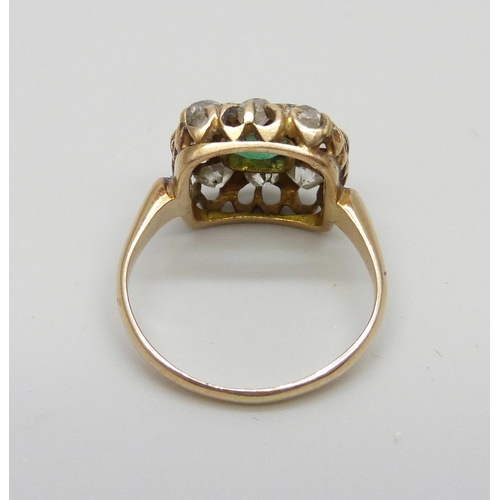 1003 - An early Victorian yellow metal ring set with a central emerald and ten diamonds, approximately 1.2c... 