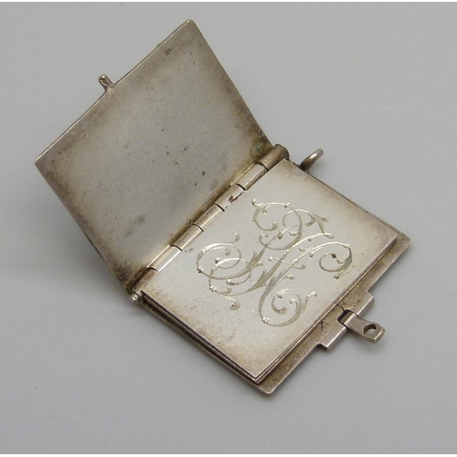 1005 - An Art Nouveau 'Memorable Days' white metal book locket charm, a/f, and a silver American Victorian ... 