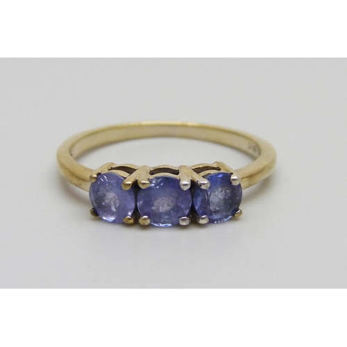 1009 - A silver gilt tanzanite three stone ring, N