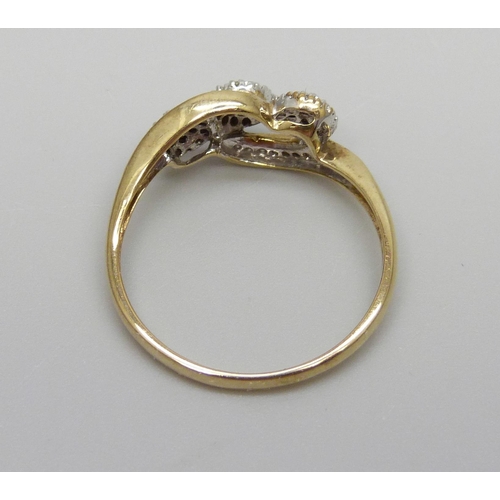 1011 - A 9ct gold and diamond triple cluster ring with diamond set shoulders, 2.6g, U/V