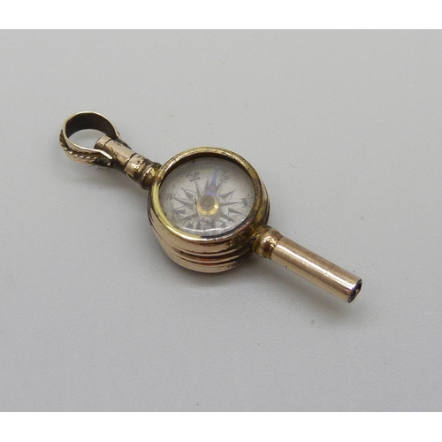 1014 - An antique yellow metal pocket watch key set with a compass and intaglio, compass hand loose, 2.3g