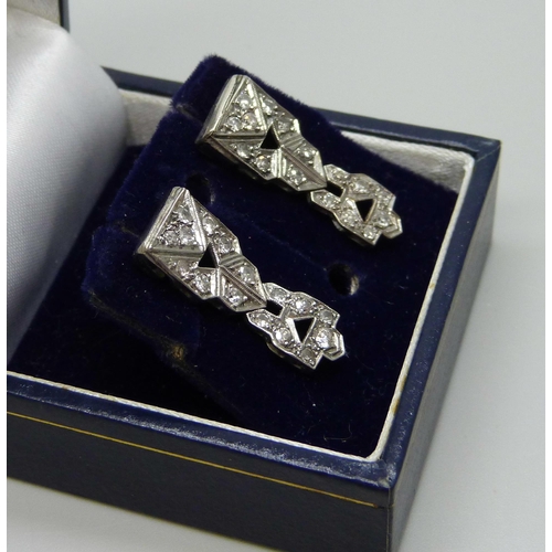 1017 - A pair of white metal Art Deco and diamond set earrings, possibly converted from a wristwatch, boxed... 