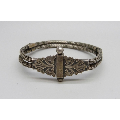 1028 - An Eastern bracelet, tests as silver, 23g