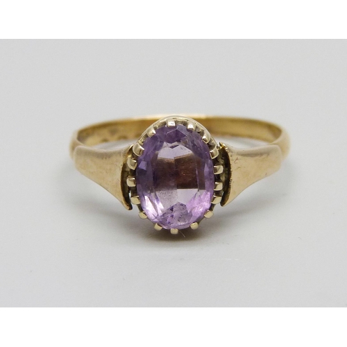 1048 - A yellow metal and amethyst ring marked 22ct, adapted from a wedding band, in a vintage box, 2.5g, O