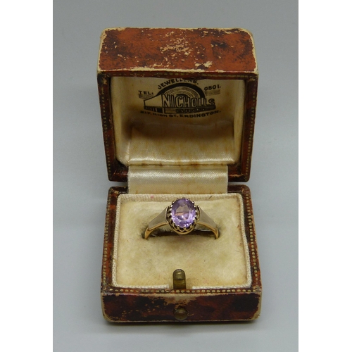 1048 - A yellow metal and amethyst ring marked 22ct, adapted from a wedding band, in a vintage box, 2.5g, O