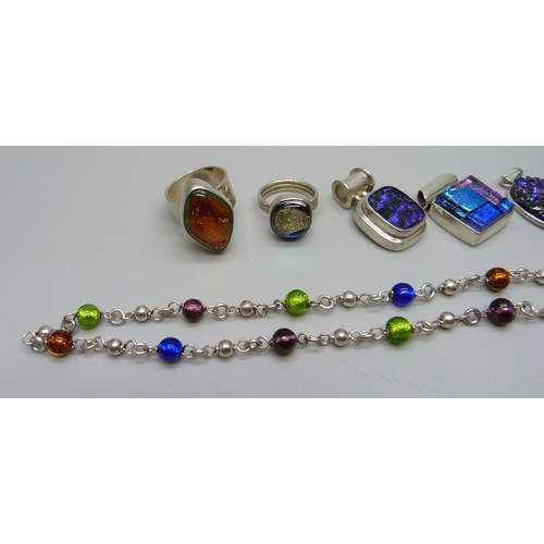 1057 - A collection of silver and dichroic glass rings and pendants, and a foil bead silver necklace, 57g