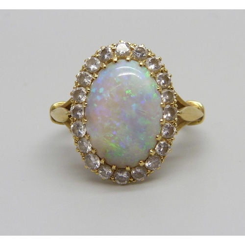 1071 - An 18ct gold opal and diamond cluster ring, H.B & Co, opal 1.3cm x 0.9cm, shallow chip to opal, 5.1g... 