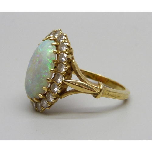 1071 - An 18ct gold opal and diamond cluster ring, H.B & Co, opal 1.3cm x 0.9cm, shallow chip to opal, 5.1g... 