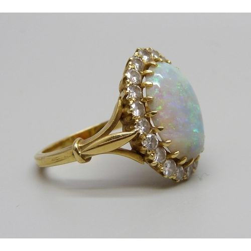 1071 - An 18ct gold opal and diamond cluster ring, H.B & Co, opal 1.3cm x 0.9cm, shallow chip to opal, 5.1g... 