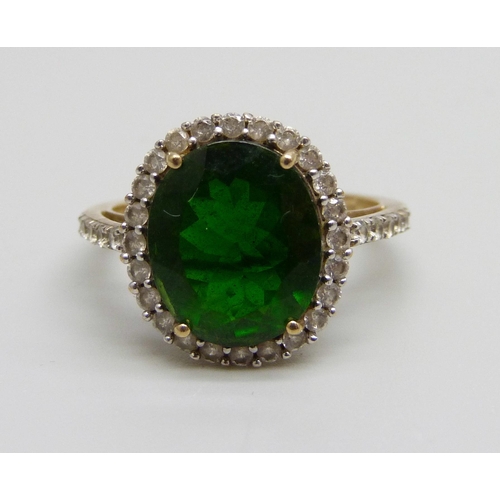 1075 - A 9ct gold ring set with a central green stone and white spinel halo and shoulders, 3.4g, P/Q