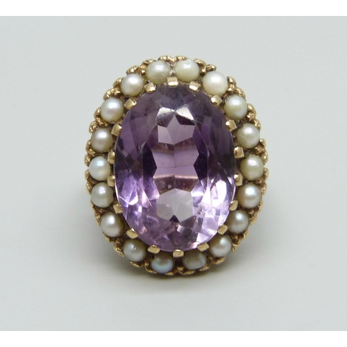 1078 - A 9ct gold and amethyst ring with a seed pearl border, a/f some pearls replaced/chipped and shank mi... 