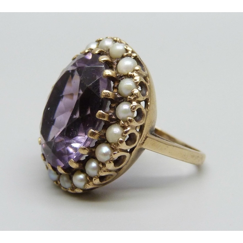 1078 - A 9ct gold and amethyst ring with a seed pearl border, a/f some pearls replaced/chipped and shank mi... 