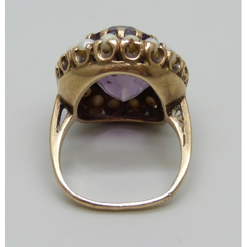 1078 - A 9ct gold and amethyst ring with a seed pearl border, a/f some pearls replaced/chipped and shank mi... 