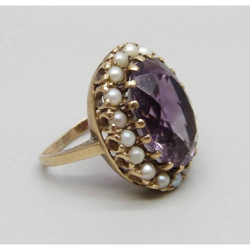 1078 - A 9ct gold and amethyst ring with a seed pearl border, a/f some pearls replaced/chipped and shank mi... 