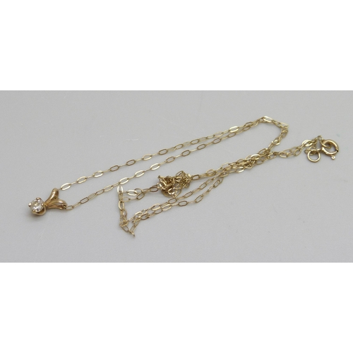 1087 - A fine 9ct gold chain with a yellow metal diamond set pendant, 0.4g