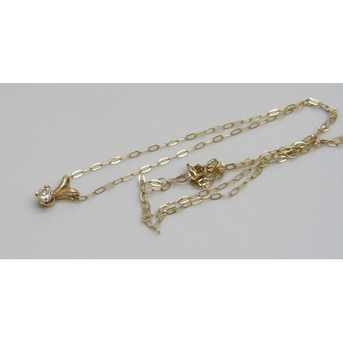 1087 - A fine 9ct gold chain with a yellow metal diamond set pendant, 0.4g