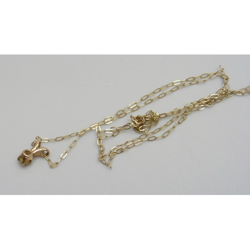 1087 - A fine 9ct gold chain with a yellow metal diamond set pendant, 0.4g