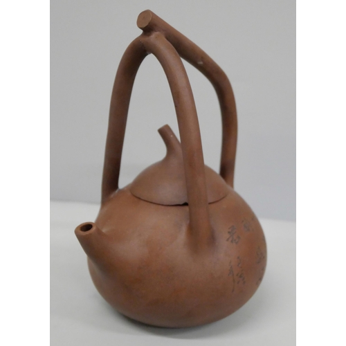 621 - A Chinese clay Yixing teapot, handle repaired