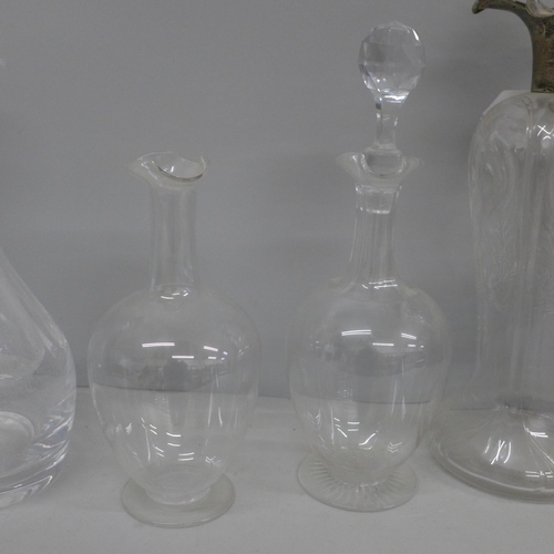 670 - A glass decanter with hallmarked silver top, top a/f and three other glass decanters, one large, two... 