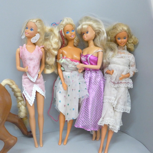 724 - A collection of eight Barbie dolls and a horse