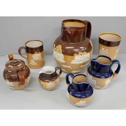 818 - A collection of Royal Doulton stoneware;- four jugs, a teapot, a cup and a mug