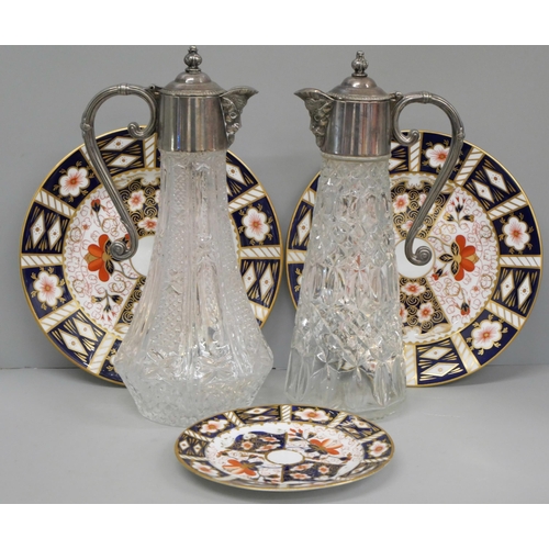 820 - Two Royal Crown Derby 2451 side plates and a tea plate and two claret jugs with silver plated tops