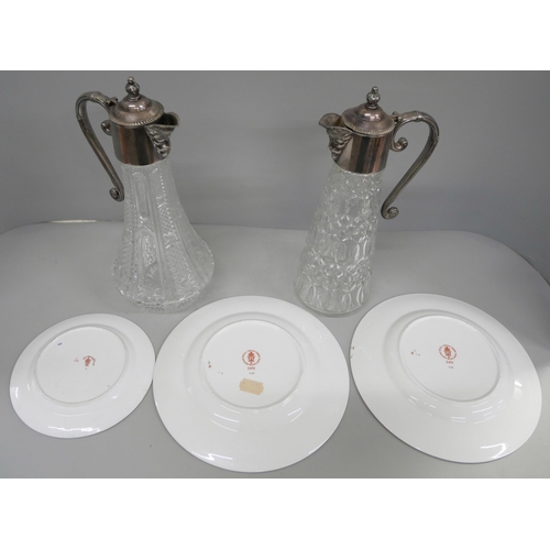 820 - Two Royal Crown Derby 2451 side plates and a tea plate and two claret jugs with silver plated tops