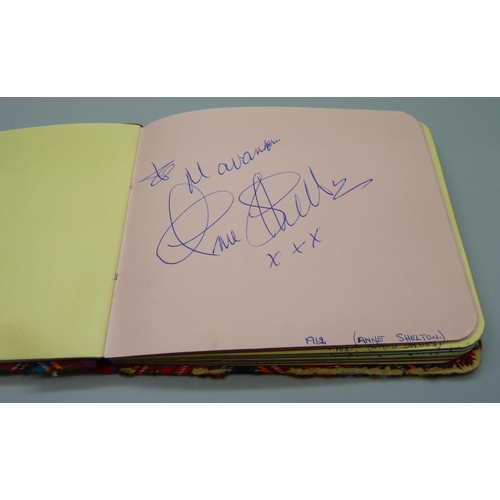 852 - A 1950s autograph album with signatures including Lionel Jeffries, Jim Reeves, Dickie Valentine, Chr... 