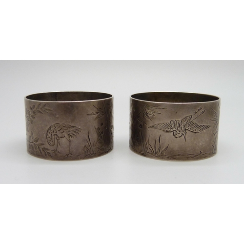 879 - A pair of Victorian silver napkin rings with bird and bamboo detail, London 1881, maker Thomas Johns... 