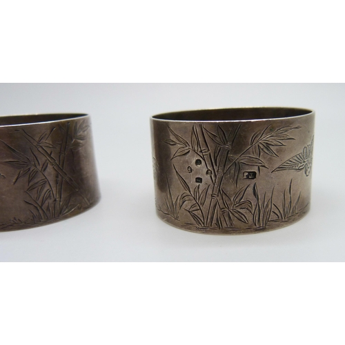 879 - A pair of Victorian silver napkin rings with bird and bamboo detail, London 1881, maker Thomas Johns... 