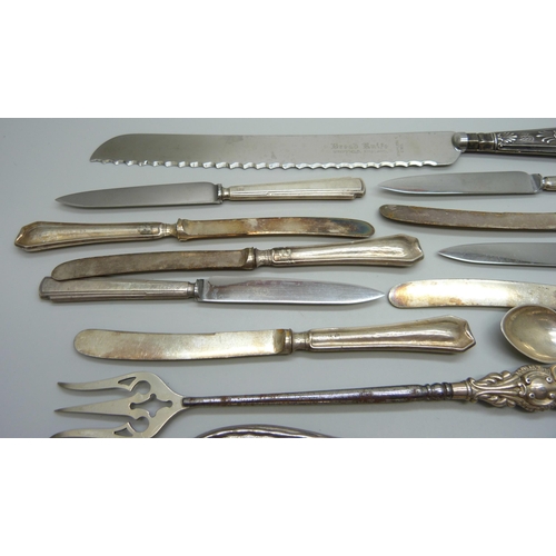 893 - Four silver spoons and a silver pickle fork, 71g, and a collection of silver handled cutlery