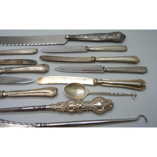 893 - Four silver spoons and a silver pickle fork, 71g, and a collection of silver handled cutlery