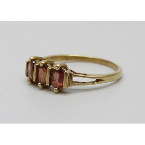 957 - A 9ct gold, three red stone ring, 1.9g, P