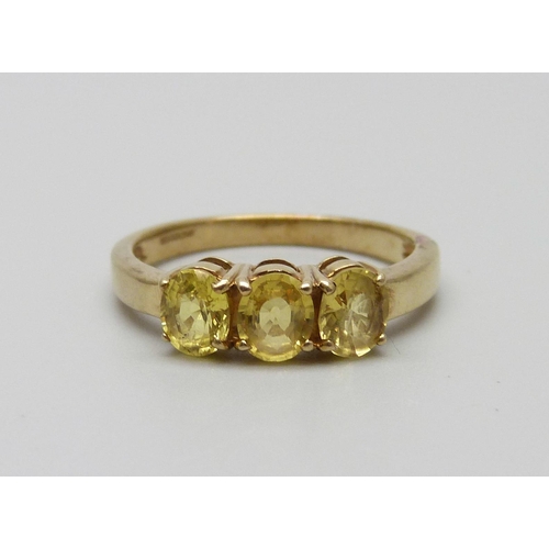 969 - A 9ct gold ring set with three yellow stones, 2.5g, N