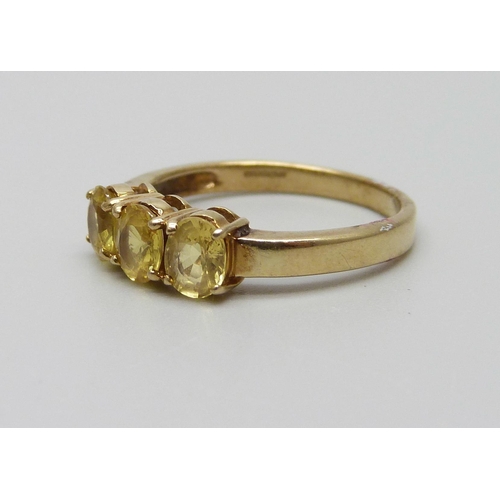 969 - A 9ct gold ring set with three yellow stones, 2.5g, N